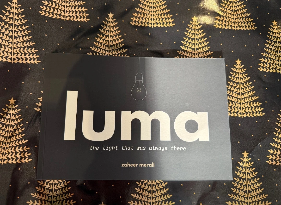 luma resting on gold-patterned gift wrap